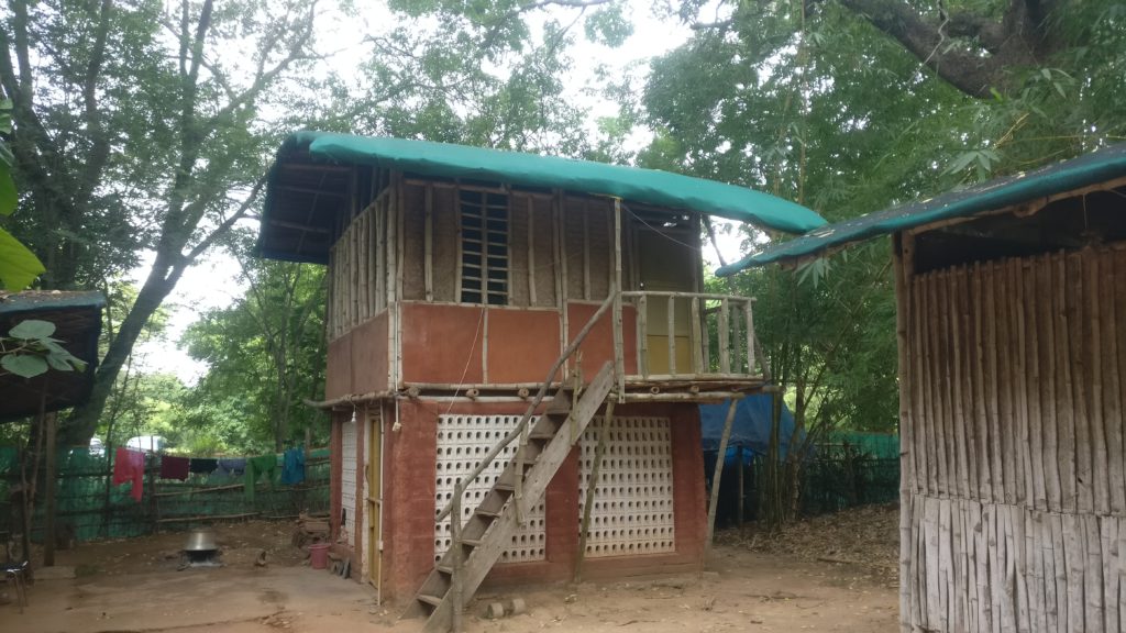 A house in the forest made in bamboo and mud.
