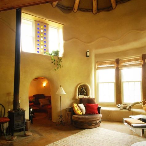 A hall in the house with furnitures and plants.